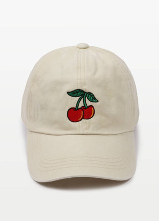 An off-white cotton baseball cap featuring an embroidered design of two red cherries with green leaves on the front, set against a plain white background.
