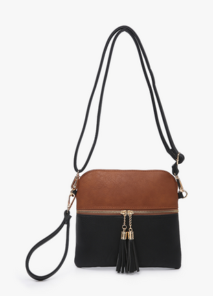 Two-tone black and brown crossbody bag with a strap on a white background
